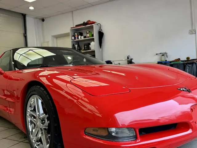 Czerwona sportowa Corvette z lśniącym lakierem w profesjonalnym studio detailingowym
