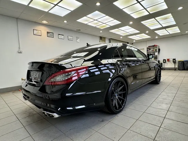 Tył czarnego Mercedesa CLS z oznaczeniami AMG i sportowym wydechem